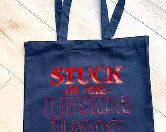 80’s Retro Hawkins Upside Down canvas bag with red holographic words.