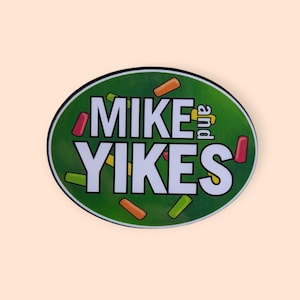May include: A round sticker with the text "MIKE and YIKES" in white, set against a green background. The sticker is decorated with colorful candy-like shapes in red, orange, yellow, and green.