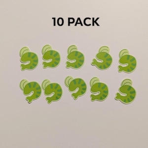 Puede incluir: Diez pegatinas verdes con forma de rana con una cabeza verde claro y un cuerpo verde más oscuro con rayas. Las pegatinas están dispuestas en dos filas de cinco. El texto "10 PACK" está en la parte superior.