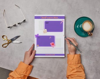 May include: A self-care list printable with purple and pink accents. The list has sections for day and night with lined spaces for writing. The printable is on a grey surface with a cup of coffee, a pair of glasses, and scissors.