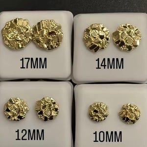 May include: Four pairs of gold-colored nugget stud earrings displayed on white cards. The earrings are in various sizes: 17MM, 14MM, 12MM, and 10MM. The earrings have a textured, irregular surface, resembling small gold nuggets.
