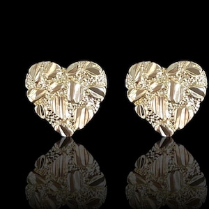 May include: A pair of gold heart-shaped earrings with a textured diamond-like pattern.