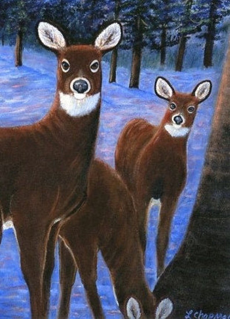 May include: Two brown deer standing in a snowy forest setting. The deer are facing the viewer, with the larger deer in the foreground and the smaller deer behind it. The deer have white markings on their faces and necks. The background is a blurry blue and white.