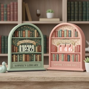 May include: Two decorative bookshelf-shaped book counters. One is mint green, the other is pink. Each has shelves of miniature books, a counter for the number of books read, and the text "BOOKS READ THIS YEAR" and "SOPHIE'S LIBRARY".