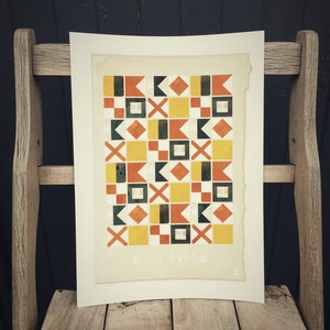 May include: A geometric print with a repeating pattern of squares, diamonds, and triangles in yellow, orange, red, black, and white. The print is on a cream-colored paper with the text "Sail Away" at the bottom.