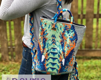 May include: A colorful crocheted backpack with a blue, green, orange, and white pattern. The backpack has a long strap and a tassel on the bottom.