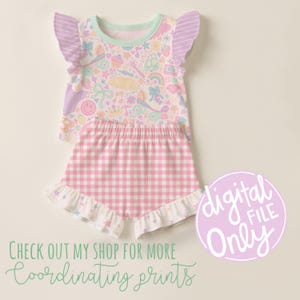 May include: A two-piece pajama set featuring a top and shorts. The top has a pastel print with various whimsical elements and ruffled sleeves. The shorts are pink and white gingham with a ruffled hem. The image also includes the text "digital file only".