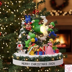 May include: A decorative Christmas tree ornament featuring Mario, Luigi, Yoshi, Bowser, Toad, and Princess Peach. The figures are arranged around a miniature tree with a green pipe and white smoke. The base is white with the text MERRY CHRISTMAS 2026.