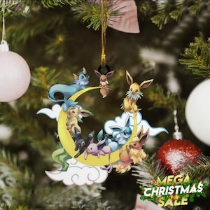 May include: A Christmas tree ornament featuring various cartoon characters on a yellow crescent moon and white clouds. The ornament is hanging on a Christmas tree with other ornaments and the text "MEGA CHRISTMAS SALE".
