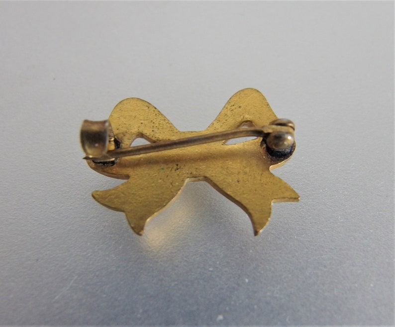 Antique White Enamel Bow Lapel Pin