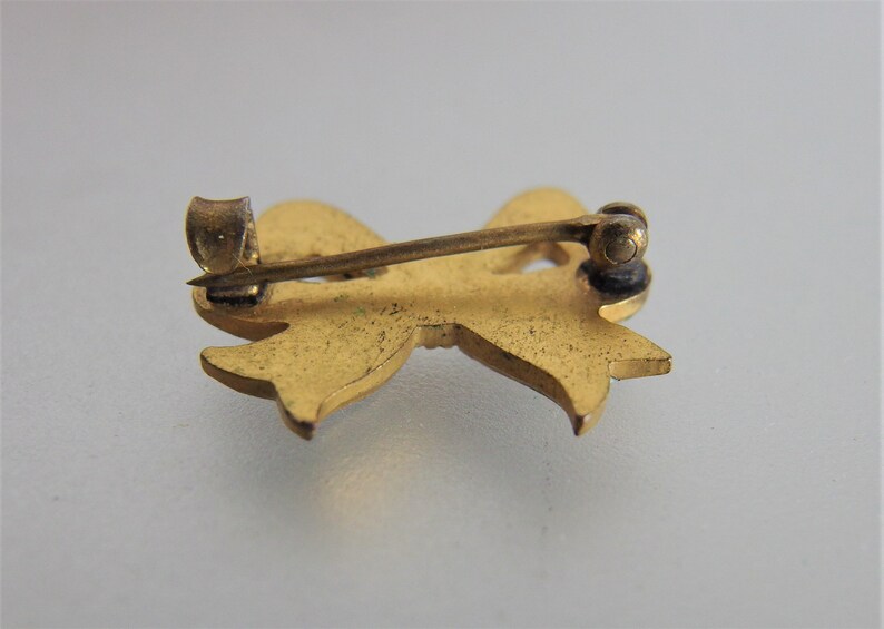 Antique White Enamel Bow Lapel Pin