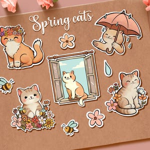 May include: A selection of cat stickers with a spring theme. The stickers depict cats with floral decorations, bees, and an umbrella. The text "Spring cats" is written in a cursive font.