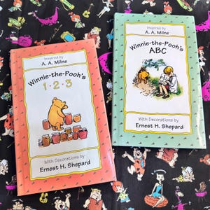 Set of 2 - Winnie The Pooh’s ABC & Winnie The Pooh’s 123 Hard Cover Books with Dust Jackets. Great for Babies First Book or Collectors Item.