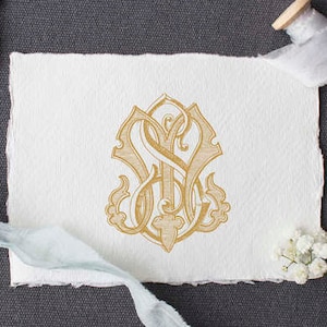 May include: A gold monogram with the letters "S" and "S" intertwined in a decorative, ornate design. The monogram is printed on a white piece of paper.