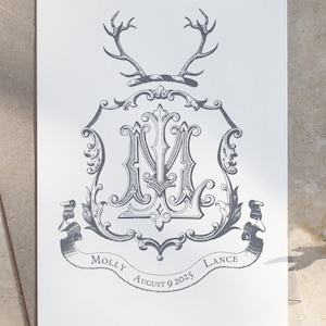 May include: A wedding invitation featuring a crest with the letters "M" and "L" intertwined, surrounded by decorative flourishes. The crest is topped with two sets of antlers and a ribbon. The text "Molly & Lance" and "August 9 2025" is below the crest.