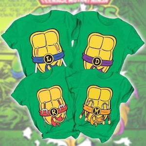 May include: Four bright green short-sleeve t-shirts featuring a yellow turtle shell graphic on the front. Each shell has a coloured belt with a letter: blue with L, purple with D, red with R, and orange with M. The shirts display various ninja weapons.