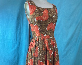 May include: A sleeveless dress with a white background and a swirling pattern of orange and brown. The dress has a square neckline and a pleated skirt.