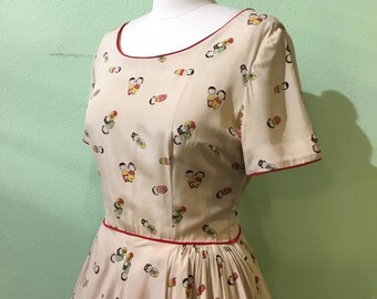 1940s 1950s W:28” beige silk Asian doll novelty print red velveteen piping short sleeve scoop neck side zip fit and flare dress