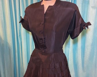 1950s W:30 LBD black taffeta short sleeve tie cuffs button front laced ribbon skirt fit and flare dress