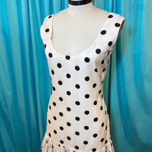 1960s B:36 NIKKI’S white black polka dot sleeveless scoop neckline scoop back tiered ruffle yellow stripe grosgrain hem mini shift dress