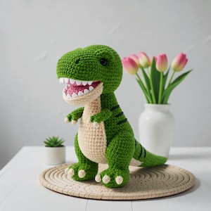 May include: A green crocheted Tyrannosaurus Rex dinosaur toy with a cream-colored belly and mouth interior. The plush figure features dark green stripes on its back, white pointed teeth, and black bead eyes, standing in a upright posture.