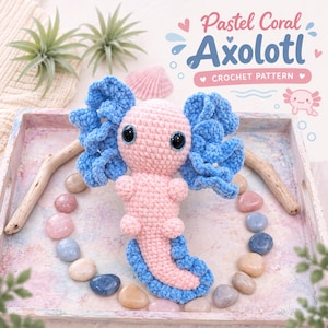 May include: A crocheted axolotl plush toy with a light pink body and bright blue frilled gills and tail fin. The toy features large black safety eyes. Text in the image reads: Pastel Coral Axolotl CROCHET PATTERN with a small axolotl icon.