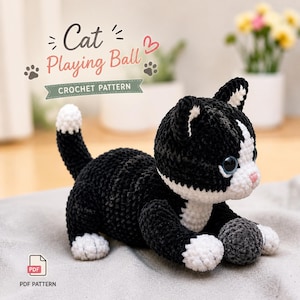 May include: A black and white crocheted cat toy with a white-tipped tail, white paws, and a white chest, playing with a small grey yarn ball. The image includes the text Cat Playing Ball CROCHET PATTERN and a PDF icon for a digital pattern.