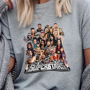 May include: Gray sweatshirt featuring a graphic of multiple WWE Superstars. The design includes the WWE logo and the word "SUPERSTARS" in a silver, metallic font. The image is a collage of various wrestlers.