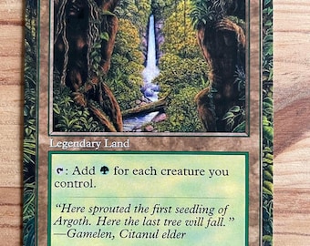 May include: A Magic: The Gathering card titled "Gaea's Cradle." The card features a lush, green landscape with a waterfall and text that reads "Legendary Land." The card's border is green and brown.