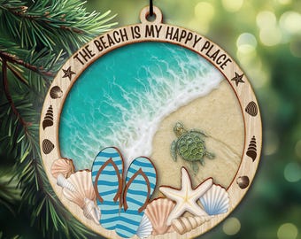 May include: Wooden beach-themed ornament with the text "THE BEACH IS MY HAPPY PLACE." The ornament features a beach scene with blue flip-flops, a starfish, a sea turtle, and seashells. The background shows a turquoise ocean and sandy beach.