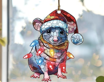 May include: A stained glass style Christmas ornament featuring a gray mouse wearing a red and white Santa hat and a scarf, with colorful Christmas lights wrapped around it.