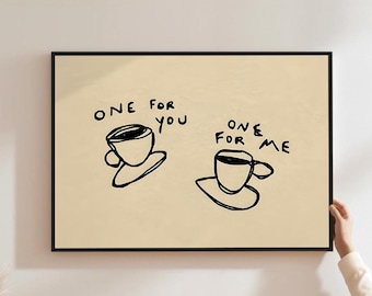 May include: A framed art print with a beige background, displaying two black line-drawn coffee cups. The text "ONE FOR YOU" and "ONE FOR ME" is written above each cup. The artwork has a simple, minimalist design.