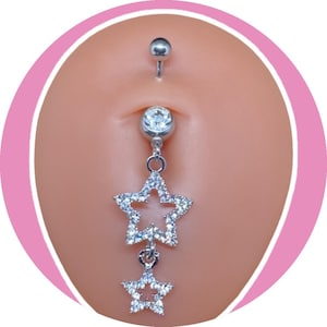 May include: A silver belly button ring with a dangling star design. The top and bottom balls are silver, and the center features a clear gem. Two star-shaped charms are encrusted with clear crystals.
