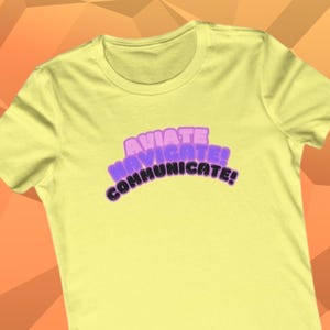 May include: A yellow t-shirt with a purple and black graphic that says "AVIATE NAVIGATE COMMUNICATE!"