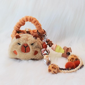 Minibolsita de peluche de capibara, estuche de auriculares de ganchillo, llavero de capibara meme kawaii