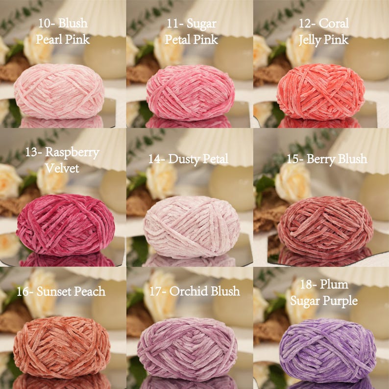May include: Nine skeins of yarn in various shades of pink, peach, and purple. Each skein is labeled with a color name, including "Blush Pearl Pink," "Sugar Petal Pink," "Coral Jelly Pink," "Raspberry Velvet," "Dusty Petal," "Berry Blush," "Sunset Peach," "Orchid Blush," and "Plum Sugar Purple."