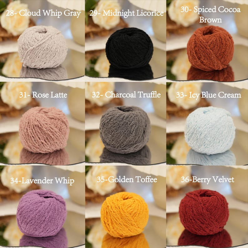 May include: Nine balls of yarn in a range of colours, including grey, black, brown, pink, grey, blue, purple, yellow, and red. Each ball is labelled with a colour name and number. The yarn balls are displayed on a reflective surface.