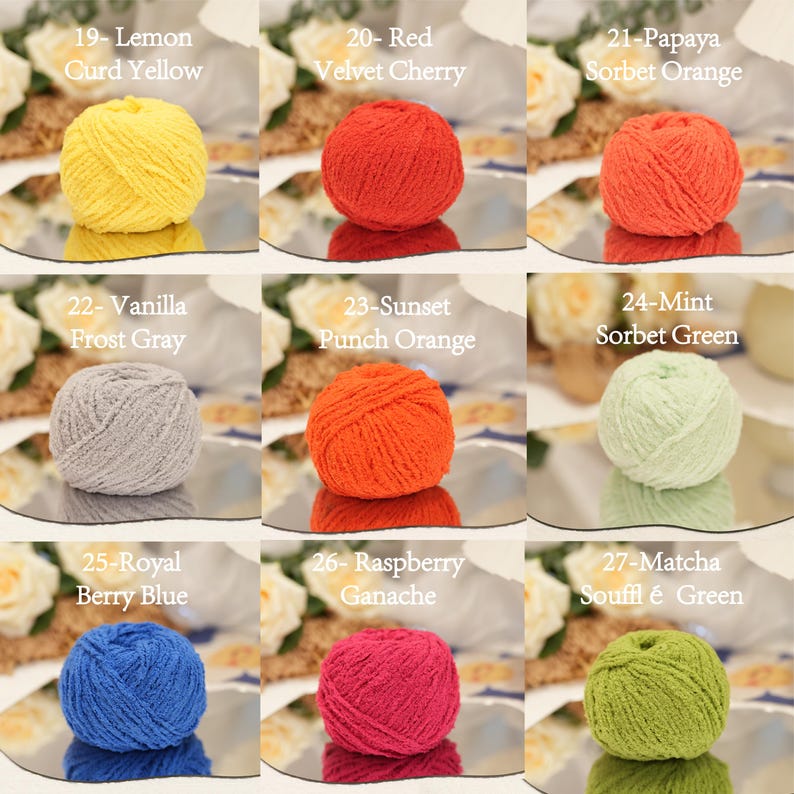 May include: A selection of nine balls of yarn in a variety of colours, including yellow, red, orange, grey, green, blue, and pink. Each ball is labelled with a colour name, such as "Lemon Curd Yellow" and "Raspberry Ganache."
