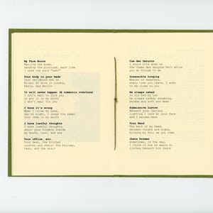 May include: A book with a green cover and white pages. The pages contain handwritten poetry with the titles "My Face Burns", "Cun des Gar&ccedil;ons", "Insensible Longing", "He sleeps naked", "Submissive Lustre", "Your Hand", and "Jeans Dreams".