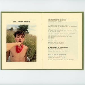 May include: A book with a green cover and white pages. The book is open to a page with a photo of a young man with a red bandana around his neck. The text on the page reads "III. OTHER PEOPLE" and "From A Hotel Room in Albania".