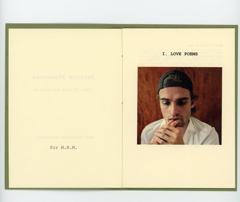 May include: A book with a green cover and a photo of a person wearing a baseball cap. The text on the page reads "I. LOVE POEMS".