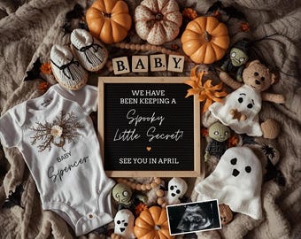 May include: A Halloween-themed baby announcement with pumpkins, baby shoes, and plush ghosts. A white onesie with the name "Spencer" is displayed next to a letter board that reads "We have been keeping a Spooky Little Secret! See you in April."