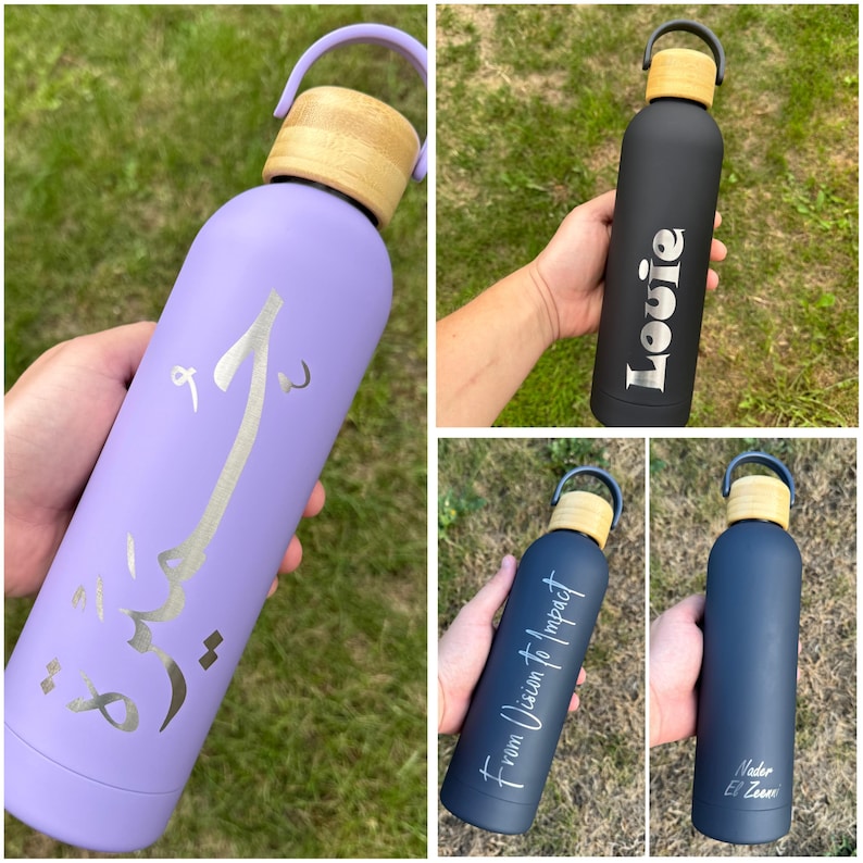 Four personalised bamboo-lid water bottles in black, navy, and lilac. Custom engraved with names, Arabic script, or phrases like “From Vision to Impact.” Reusable insulated bottles ideal for corporate gifts, daily hydration, or personal use.