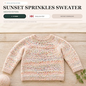 May include: A digital knitting pattern for a Sunset Sprinkles Sweater, sized for 2-14 years. The sweater is a long-sleeved, round-yoke pullover in a light peach yarn speckled with multicoloured dots, featuring ribbed cuffs, a ribbed neckline, and a ribbed hem.