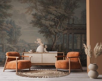 May include: Two orange suede armchairs with wooden frames sit in front of a wooden cabinet with two drawers. The chairs are facing each other and are positioned in front of a rug. The background is a mural of a landscape with trees and a building.
