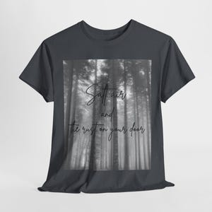 May include: A dark grey t-shirt with a black and white photo of a forest on the front. The text "Salt air and the rust on your door" is printed on the photo.