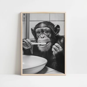 May include: A black and white photograph of a chimpanzee brushing its teeth with a toothbrush. The chimpanzee is sitting in a bathroom and has a sink in front of it.