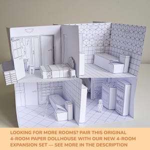 May include: A four-room paper dollhouse featuring black and white line art illustrations of a bedroom, bathroom, and kitchen. The structure includes paper furniture like a bed, bathtub, toilet, stove, and shelving units. Text at the bottom reads: LOOKING FOR MORE ROOMS? PAIR THIS ORIGINAL 4-ROOM PAPER DOLLHOUSE WITH OUR NEW 4-ROOM EXPANSION SET &mdash; SEE MORE IN THE DESCRIPTION.