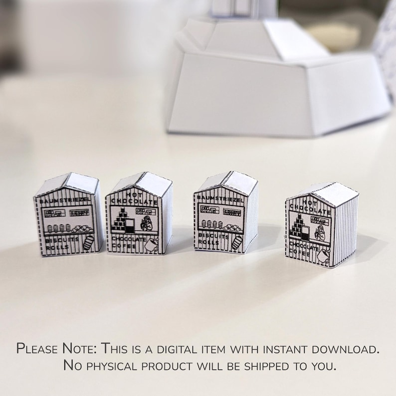 May include: Four miniature paper shop models with black and white printed details. Each shop has a gabled roof and a storefront design with text that includes "Hot Chocolate" and "Biscuits Rolls". The image also includes the text: "THIS IS A DIGITAL ITEM WITH INSTANT DOWNLOAD."