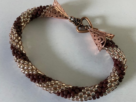 Amber and burnt plum crochet beaded bangle with rose gold heart finish